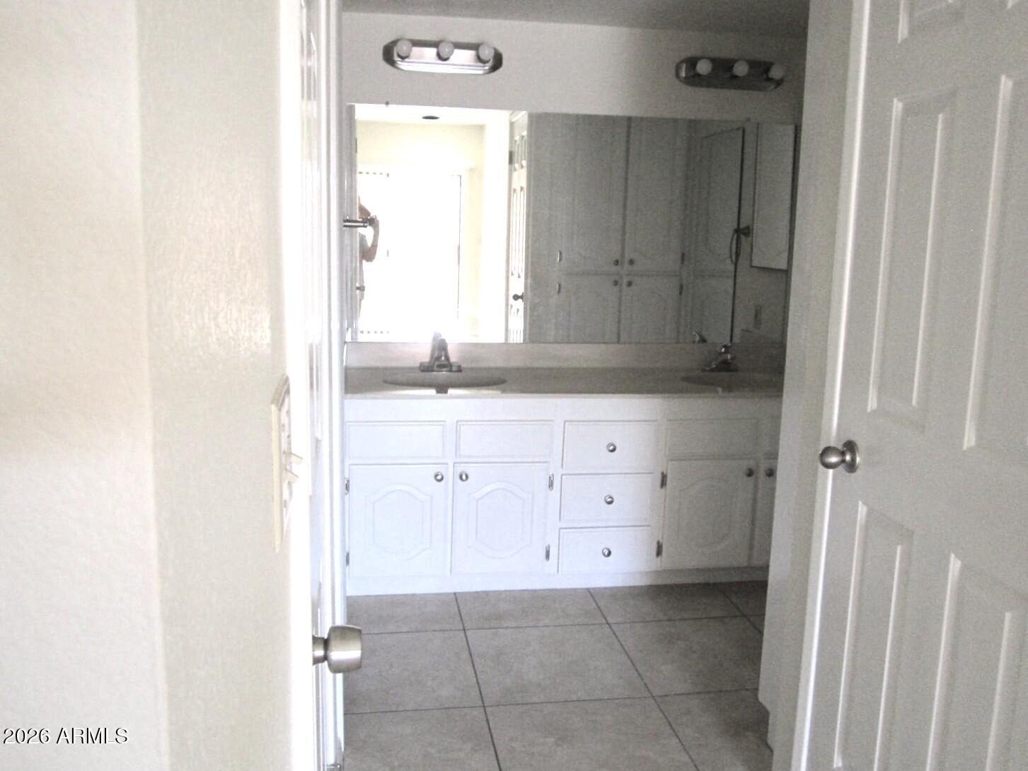 4303 East Cactus Road, Unit 419 Phoenix, AZ 85032 - Photo 12 of 34 a bathroom with a sink a mirror and a vanity