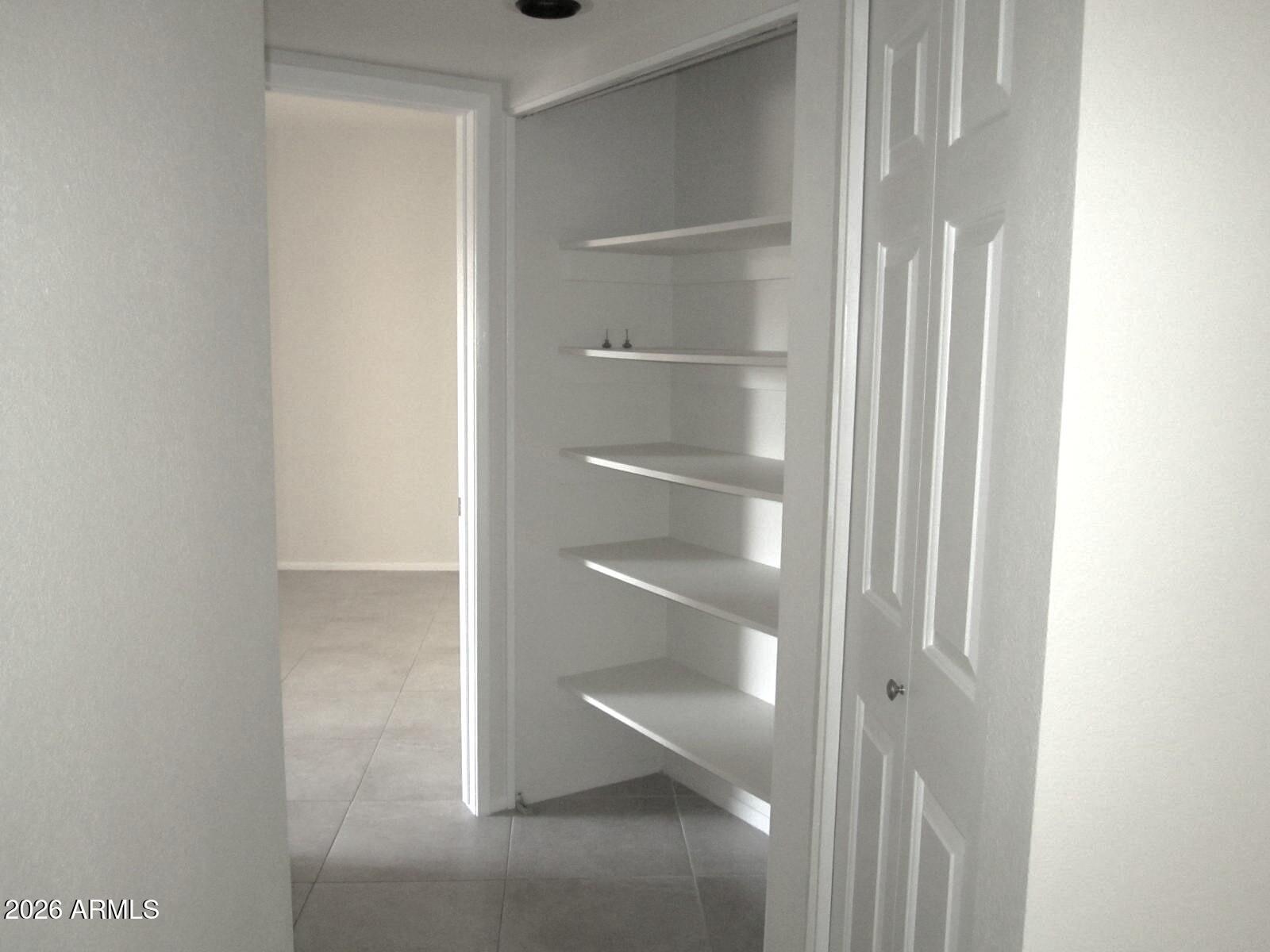 4303 East Cactus Road, Unit 419 Phoenix, AZ 85032 - Photo 14 of 34 a view of walk in closet with empty racks