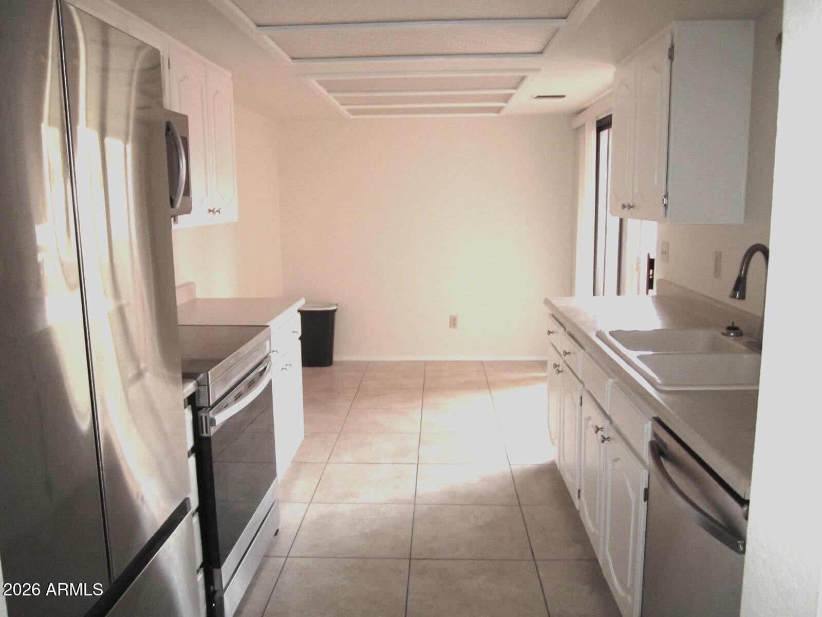 4303 East Cactus Road, Unit 419 Phoenix, AZ 85032 - Photo 3 of 34 a kitchen with a sink stove and refrigerator