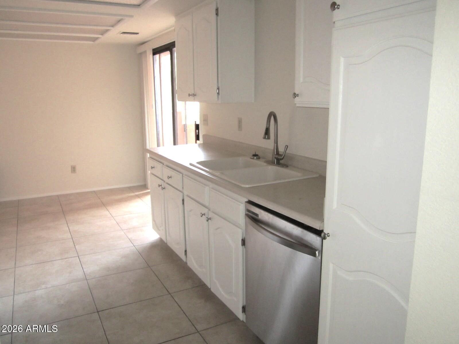 4303 East Cactus Road, Unit 419 Phoenix, AZ 85032 - Photo 4 of 34 a kitchen with a sink and cabinets