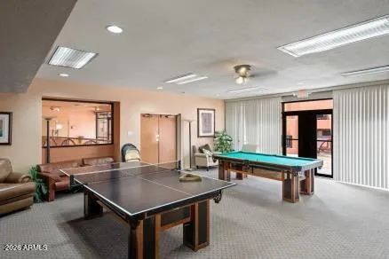 a room with furniture pool table and windows
