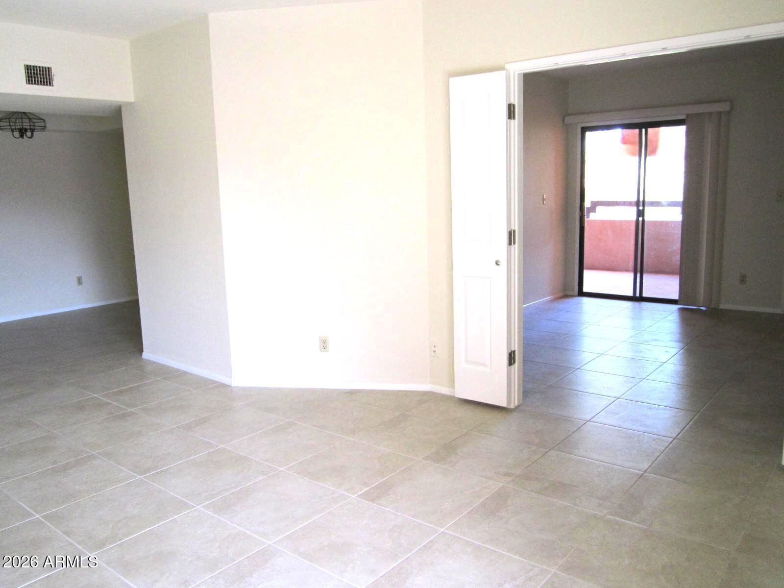 4303 East Cactus Road, Unit 419 Phoenix, AZ 85032 - Photo 7 of 34 an empty room with windows and closet