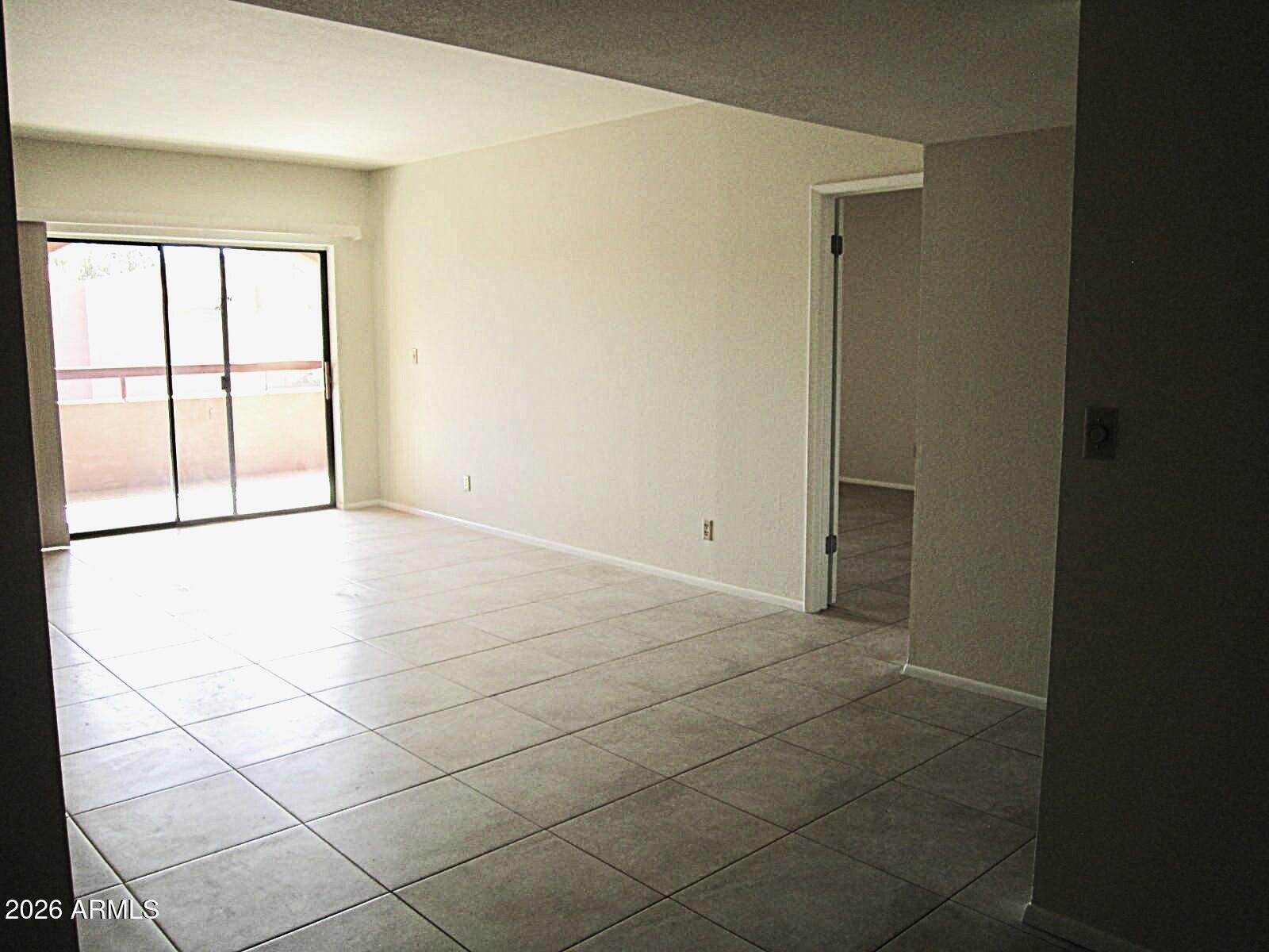 4303 East Cactus Road, Unit 419 Phoenix, AZ 85032 - Photo 8 of 34 a view of an empty room with a window