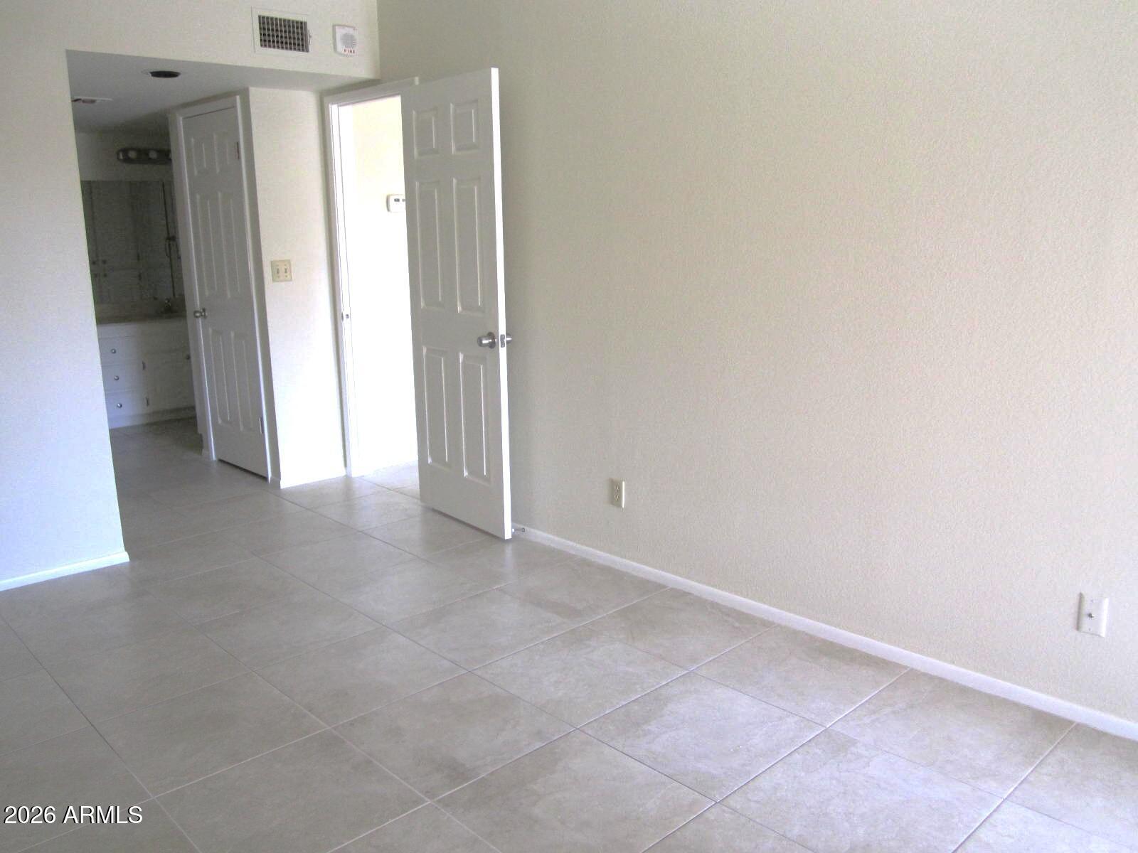4303 East Cactus Road, Unit 419 Phoenix, AZ 85032 - Photo 9 of 34 an empty room with closet