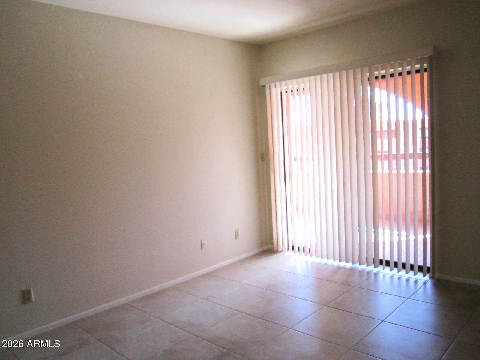 4303 East Cactus Road, Unit 419 Phoenix, AZ 85032 - Photo 10 of 34 an empty room with windows