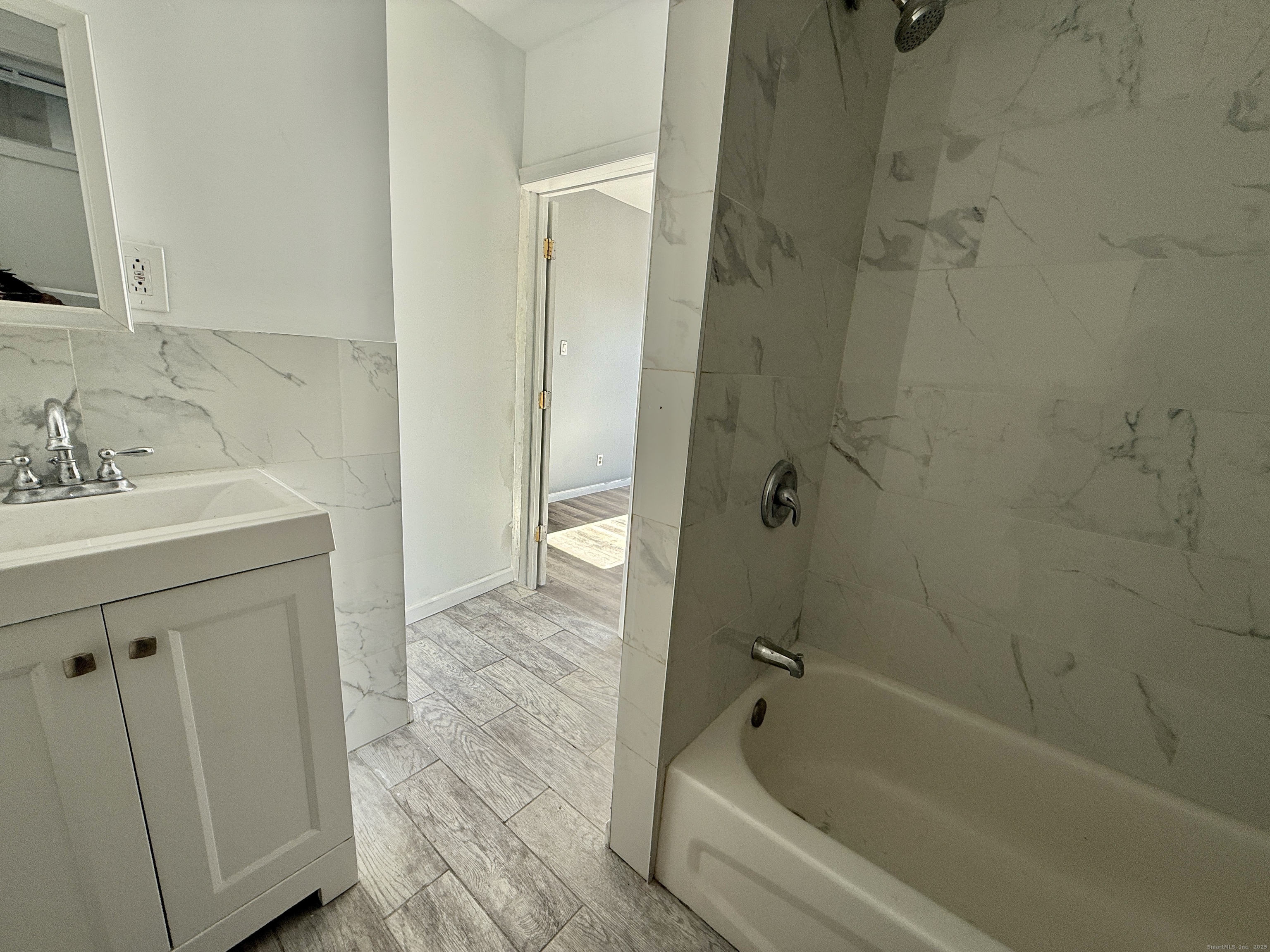 1220 Pembroke Street, Unit 3R Bridgeport, CT 06608 - Photo 5 of 8 a bathroom with a sink a toilet and shower