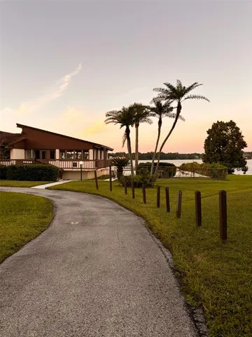 a view of swimming pool with outdoor seating and a garden