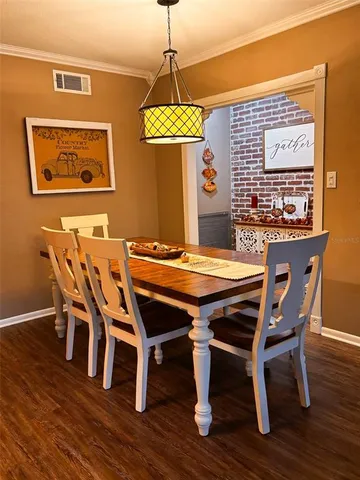 a dining room with furniture window and wooden floor