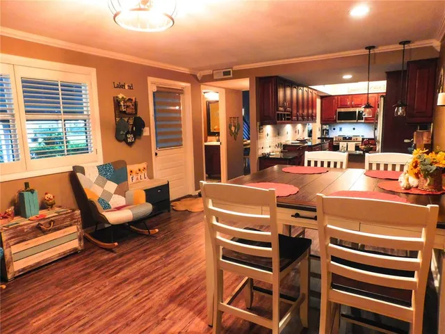 a room with furniture a flat screen tv and windows