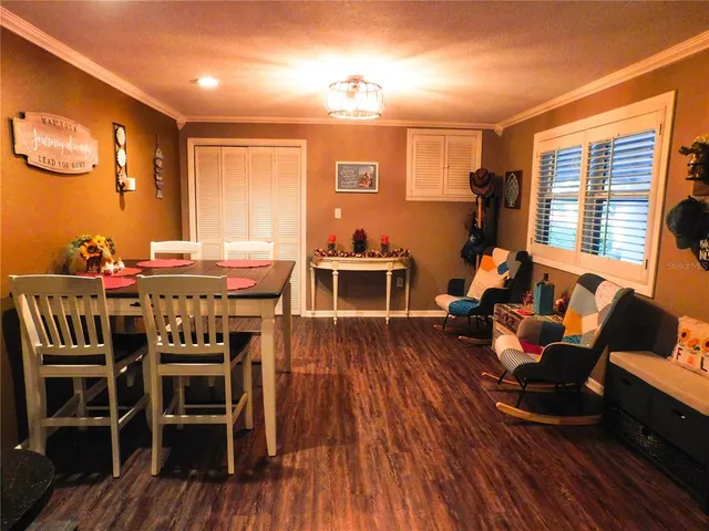a dining room with furniture window and wooden floor
