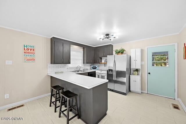 3023 Christmasville Road Jackson, TN 38305 - Photo 7 of 20 a kitchen with a refrigerator a stove a sink dishwasher with a dining table and chairs