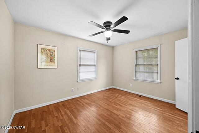 3023 Christmasville Road Jackson, TN 38305 - Photo 10 of 20 a view of a big room with wooden floor and windows