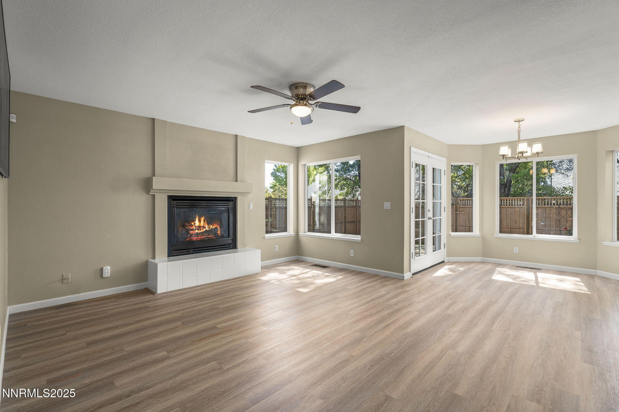 5830 Blue Horizon Drive Reno, NV 89523 - Photo 11 of 41 a view of an empty room with wooden floor fireplace and a window