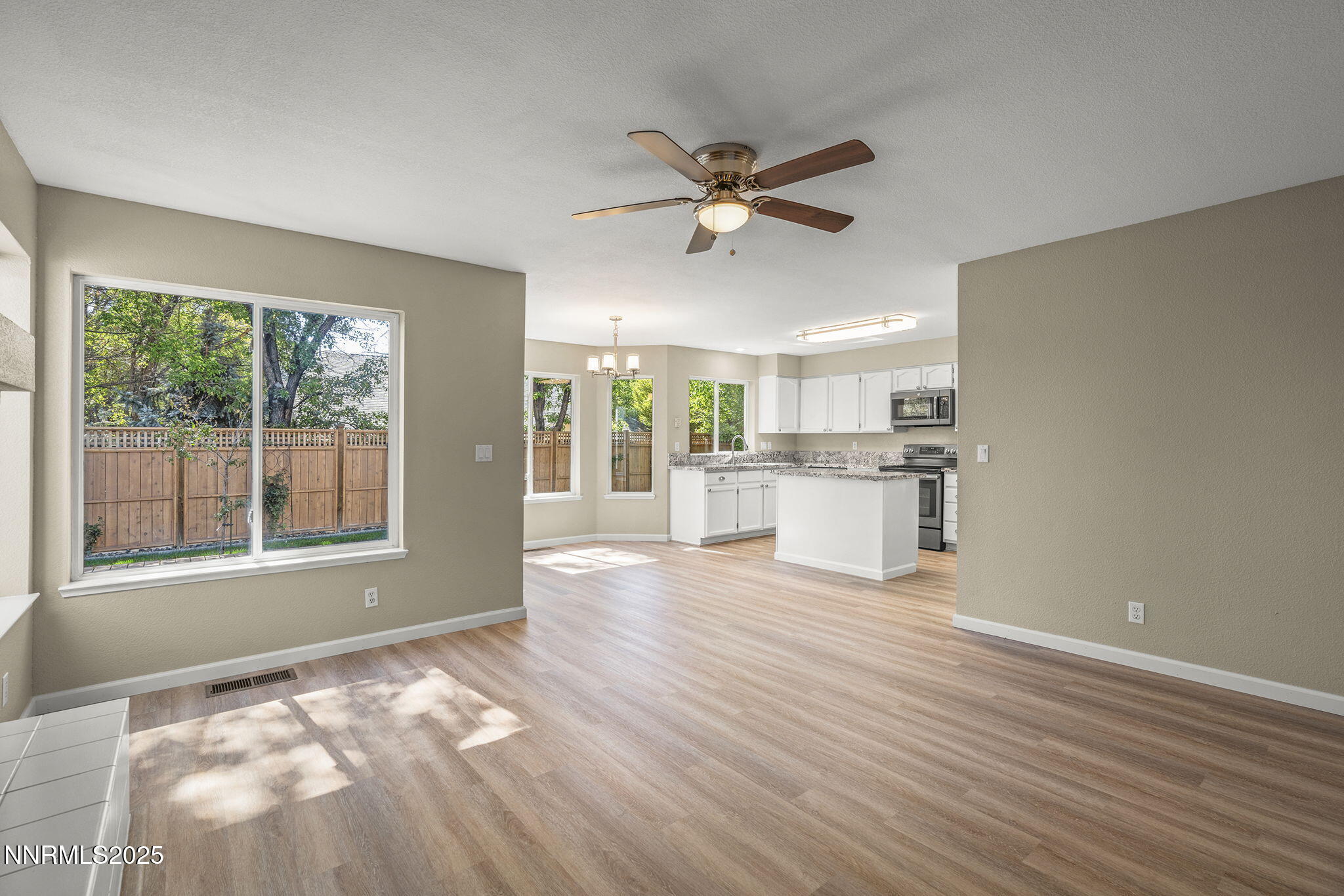 5830 Blue Horizon Drive Reno, NV 89523 - Photo 13 of 41 a view of an empty room with a window and wooden floor