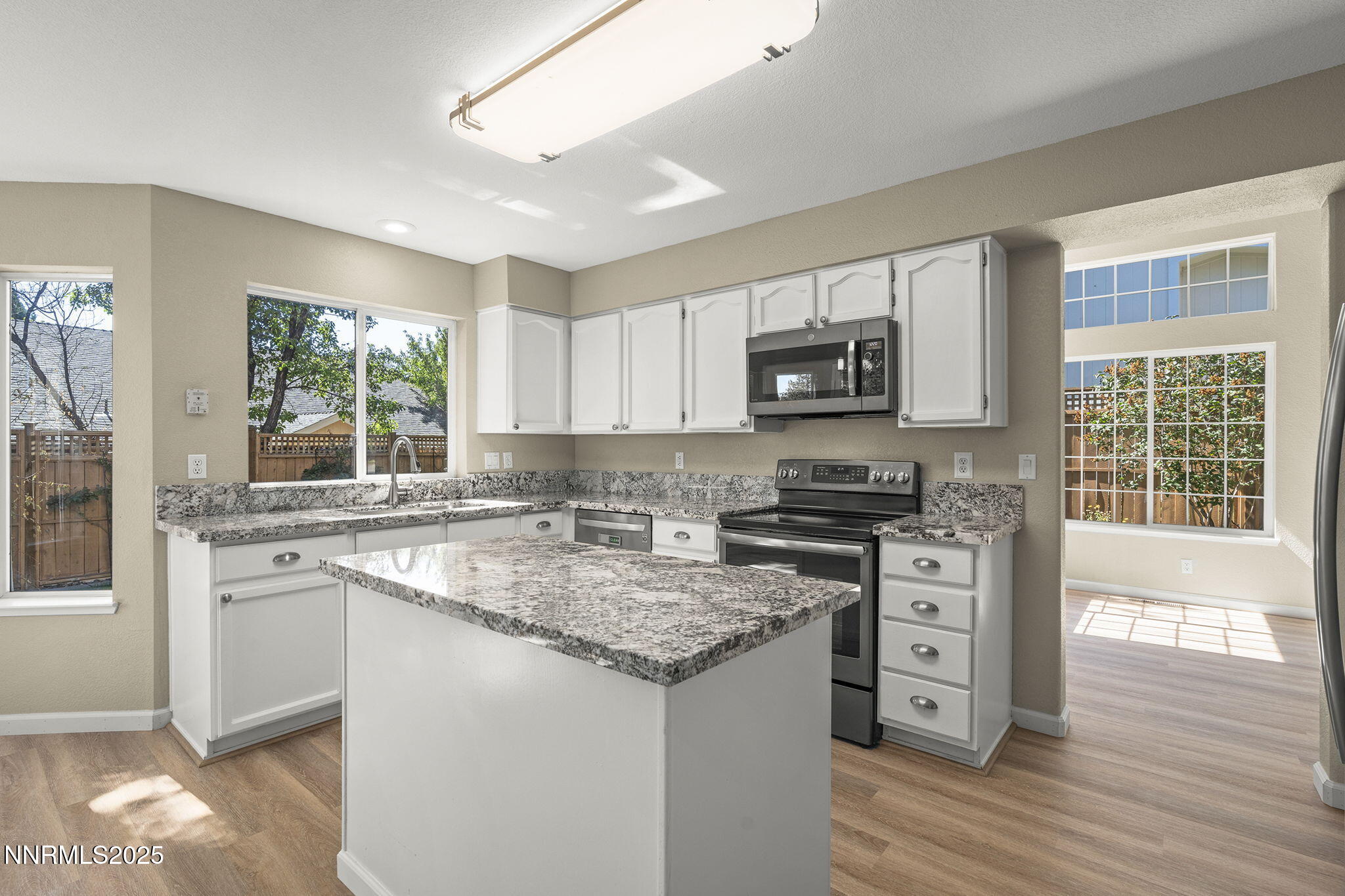 5830 Blue Horizon Drive Reno, NV 89523 - Photo 17 of 41 a kitchen with stainless steel appliances granite countertop a stove sink and microwave