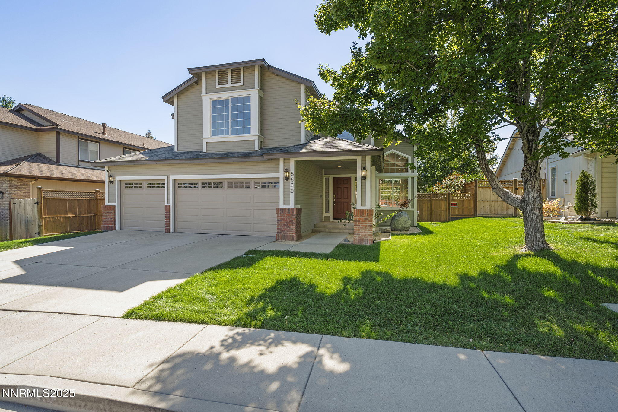 5830 Blue Horizon Drive Reno, NV 89523 - Photo 2 of 41 a front view of a house with a yard and garage