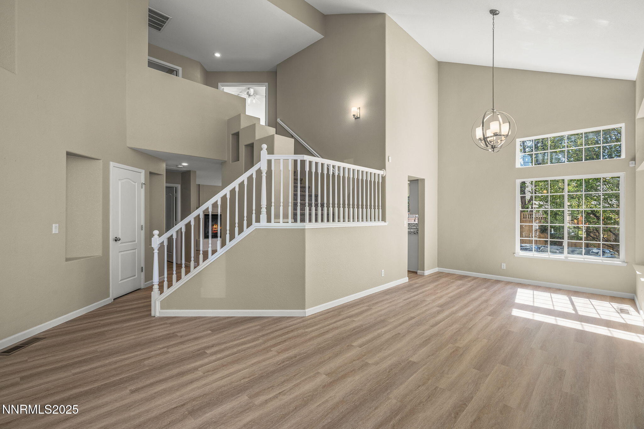 5830 Blue Horizon Drive Reno, NV 89523 - Photo 3 of 41 a view of an empty room with wooden floor and a window