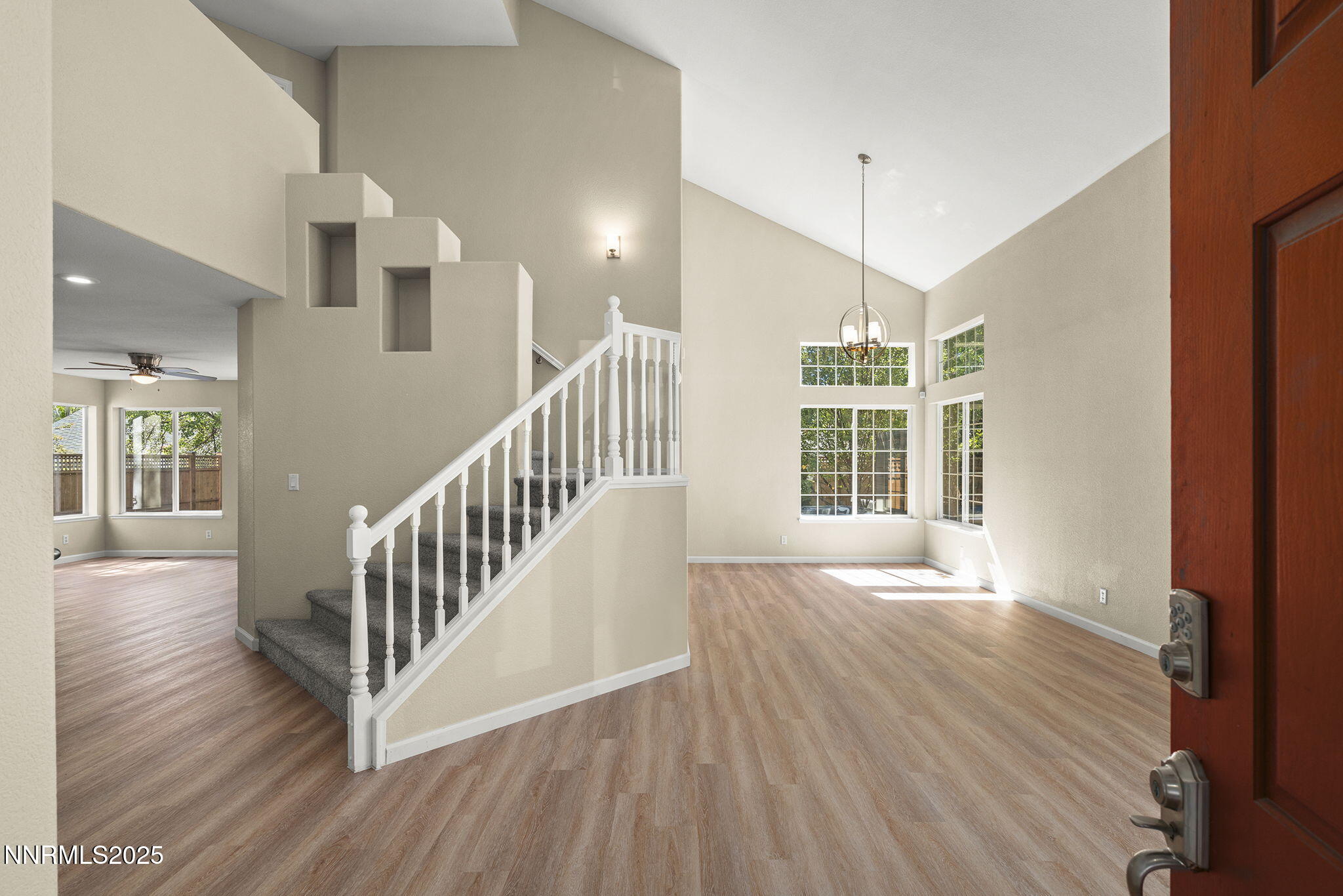 5830 Blue Horizon Drive Reno, NV 89523 - Photo 4 of 41 a view of an empty room with wooden floor and a window