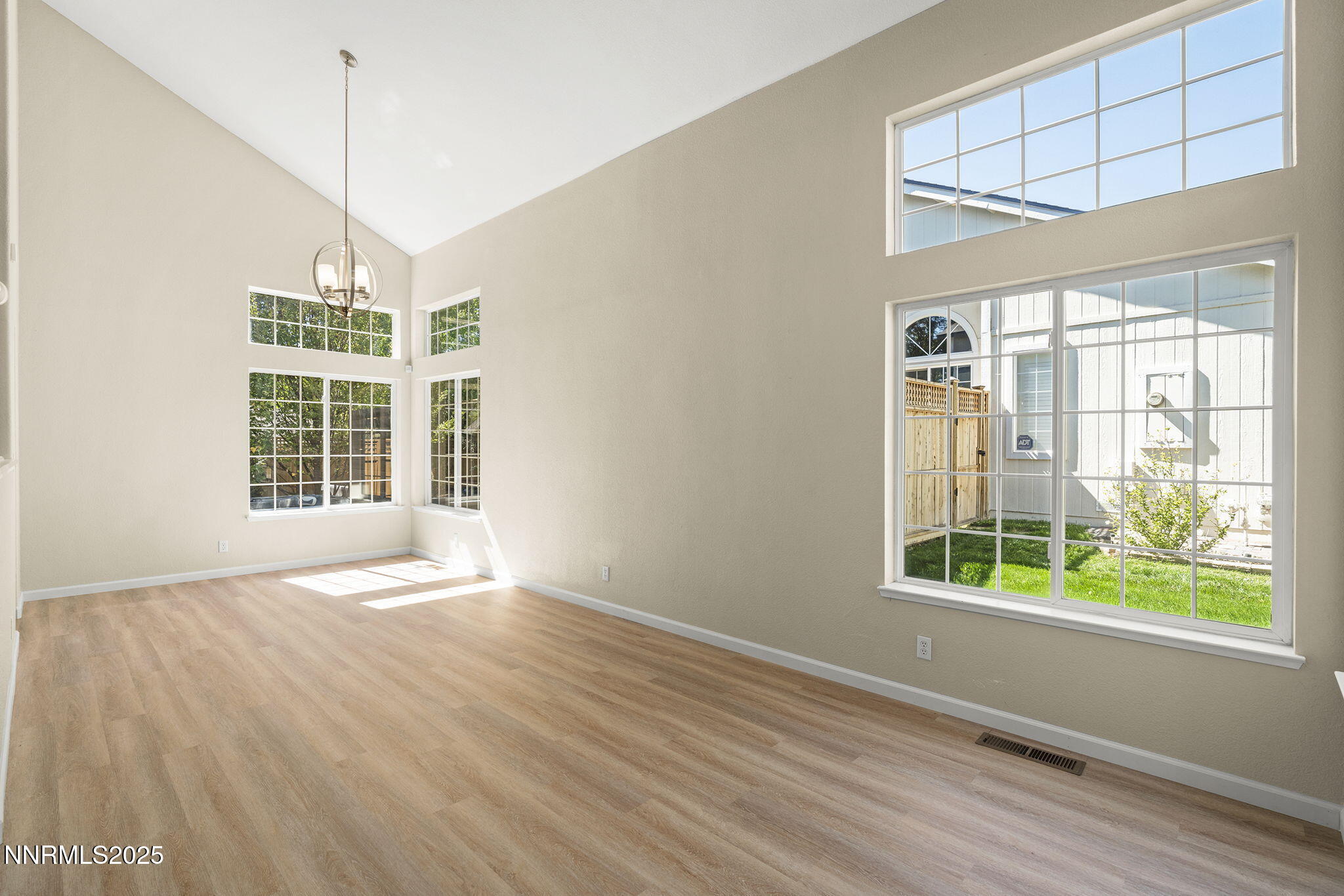 5830 Blue Horizon Drive Reno, NV 89523 - Photo 7 of 41 a view of an empty room with a window and wooden floor