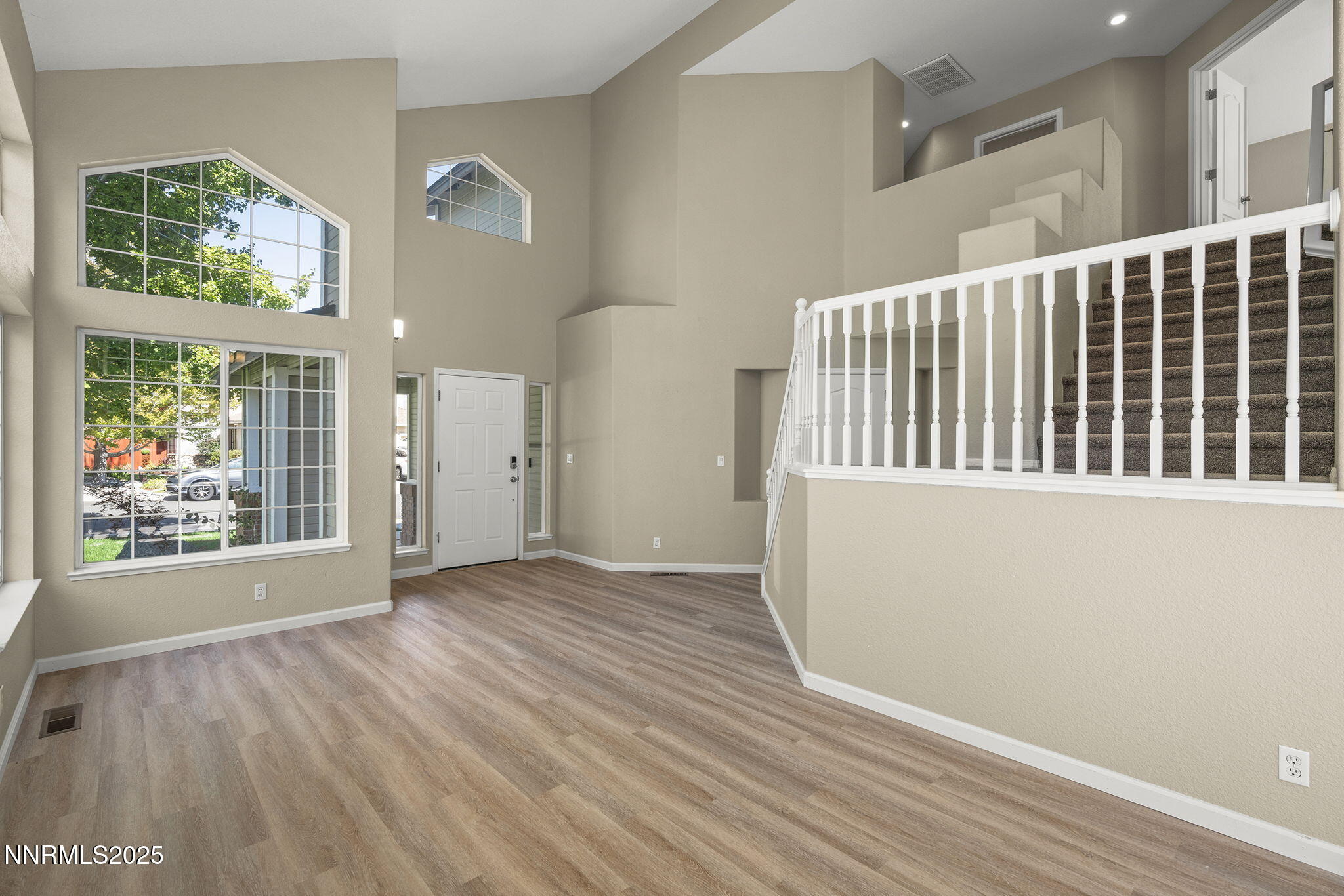 5830 Blue Horizon Drive Reno, NV 89523 - Photo 9 of 41 a view of an empty room with wooden floor and a window