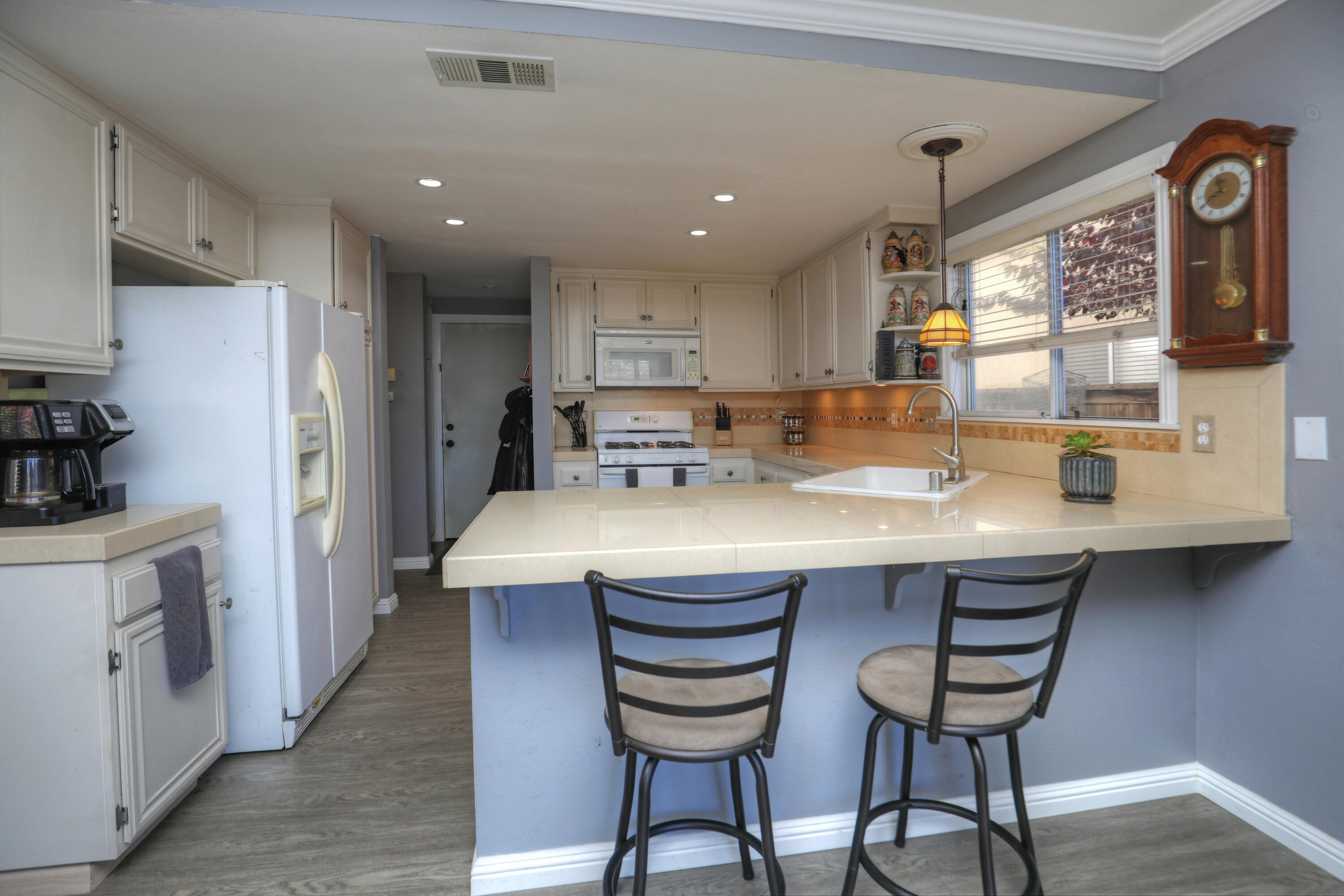 1337 Westbrook Drive Lompoc, CA 93436 - Photo 11 of 28 a kitchen with stainless steel appliances granite countertop a table chairs sink and cabinets