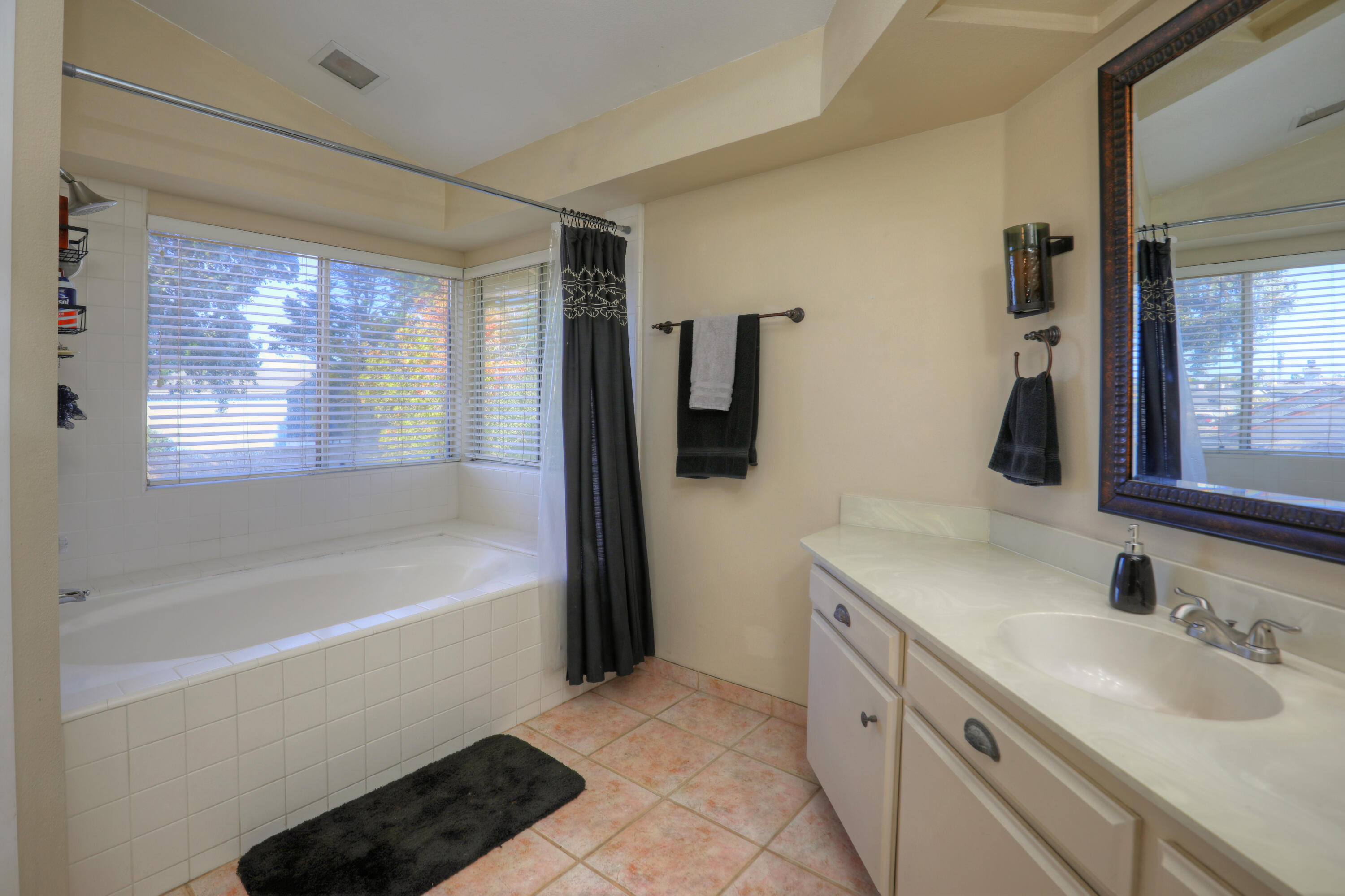 1337 Westbrook Drive Lompoc, CA 93436 - Photo 20 of 28 a bathroom with a tub sink and mirror