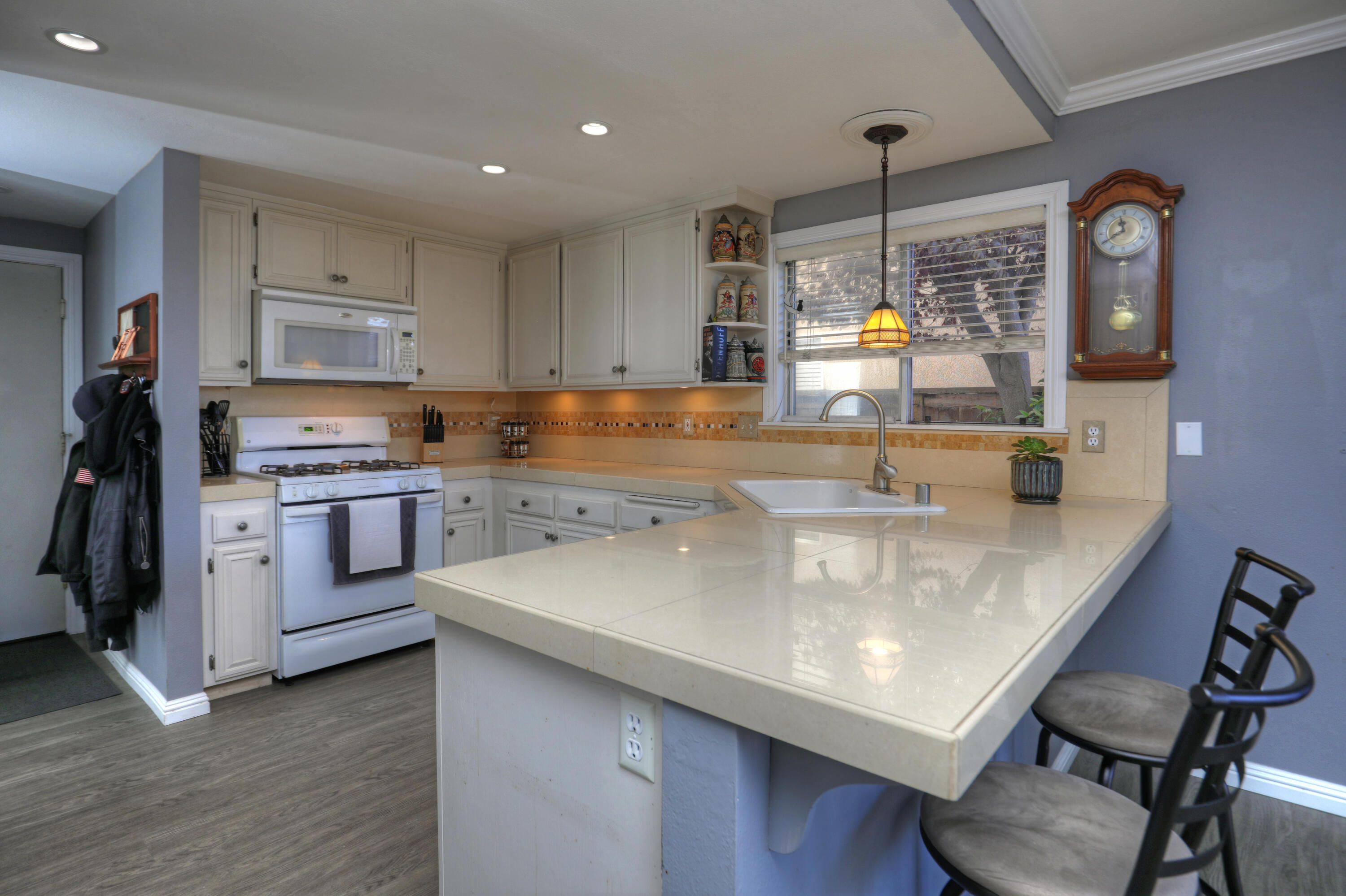 1337 Westbrook Drive Lompoc, CA 93436 - Photo 4 of 28 a kitchen with a table chairs stove and cabinets