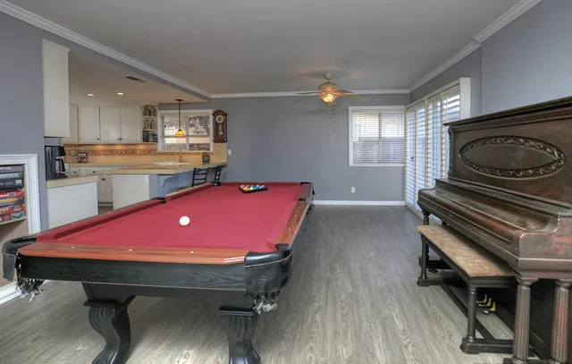 a room with pool table and windows