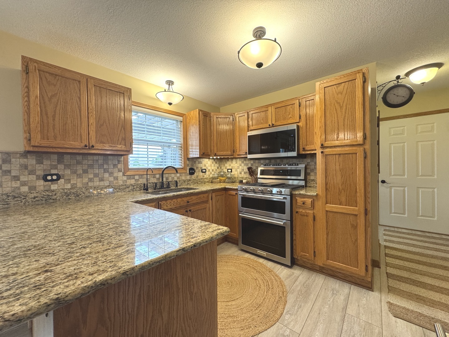 2041 Bluff Road South Kankakee, IL 60901 - Photo 11 of 39 a kitchen with stainless steel appliances granite countertop a stove refrigerator and microwave