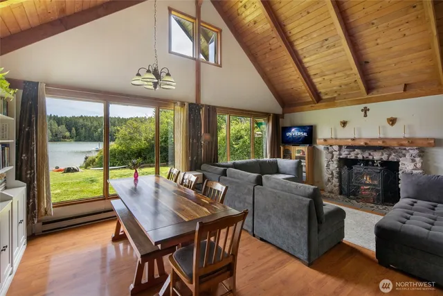a living room with fireplace furniture and a large window