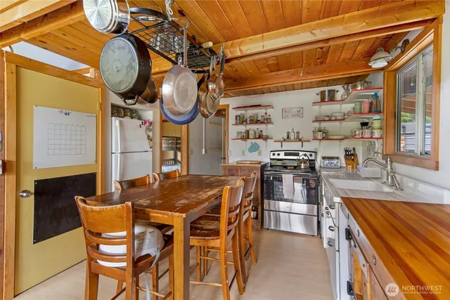 a kitchen with stainless steel appliances granite countertop a sink and a refrigerator