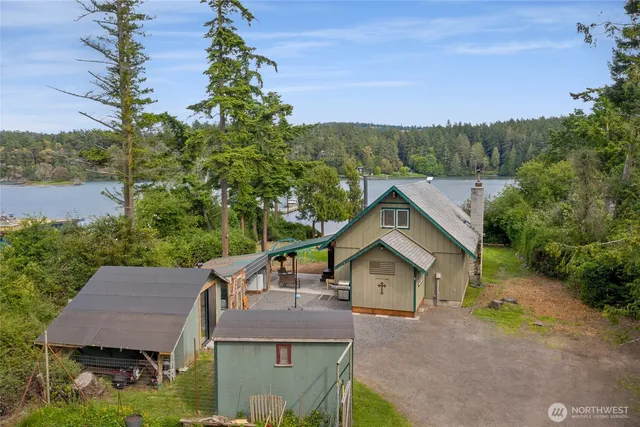 an aerial view of a house with yard and green space