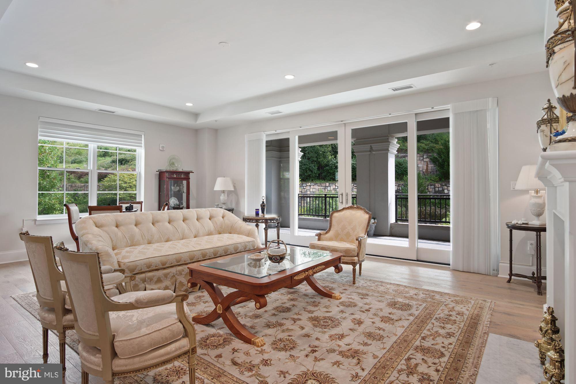 8121 River Road, Unit 431 Bethesda, MD 20817 - Photo 8 of 51 Living room with slider access to private terrace