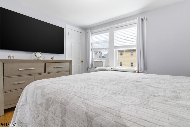 32 Cedar Avenue Elizabeth, NJ 07202 - Photo 16 of 32 a bedroom with a bed and a flat screen tv