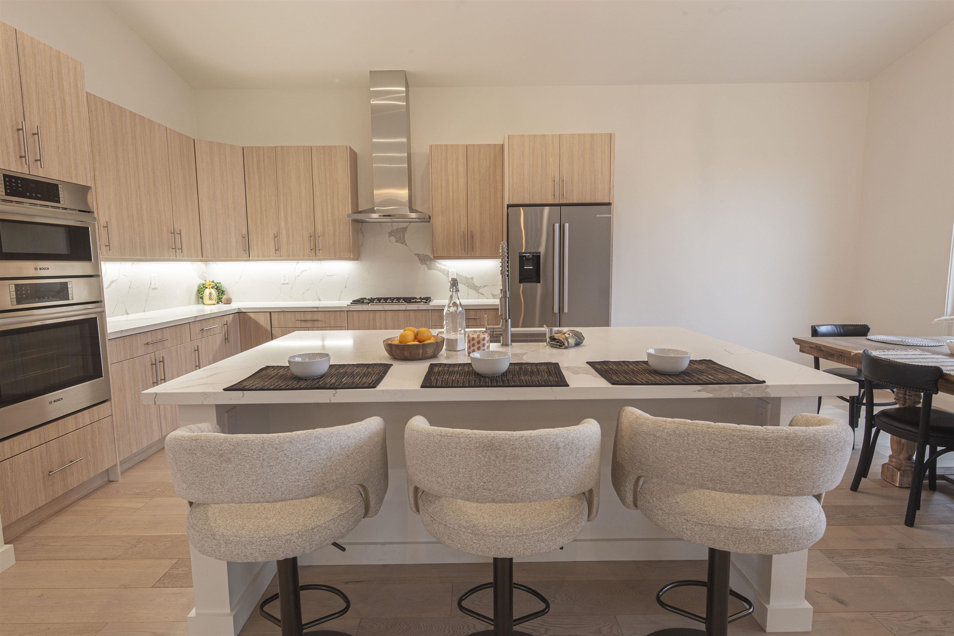 18870 Old Bridge Road Jamestown, CA 95327 - Photo 14 of 57 Kitchen featuring modern cabinets, an island with sink, light brown cabinets, stainless steel appliances, and wall chimney exhaust hood
