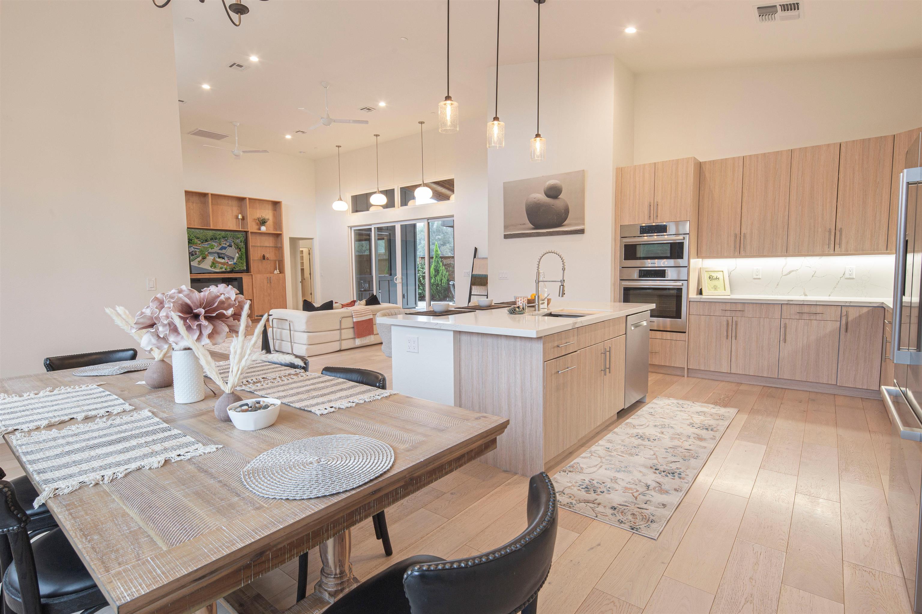 18870 Old Bridge Road Jamestown, CA 95327 - Photo 56 of 57 Kitchen featuring open floor plan, a towering ceiling, a center island with sink, pendant lighting, and light brown cabinetry