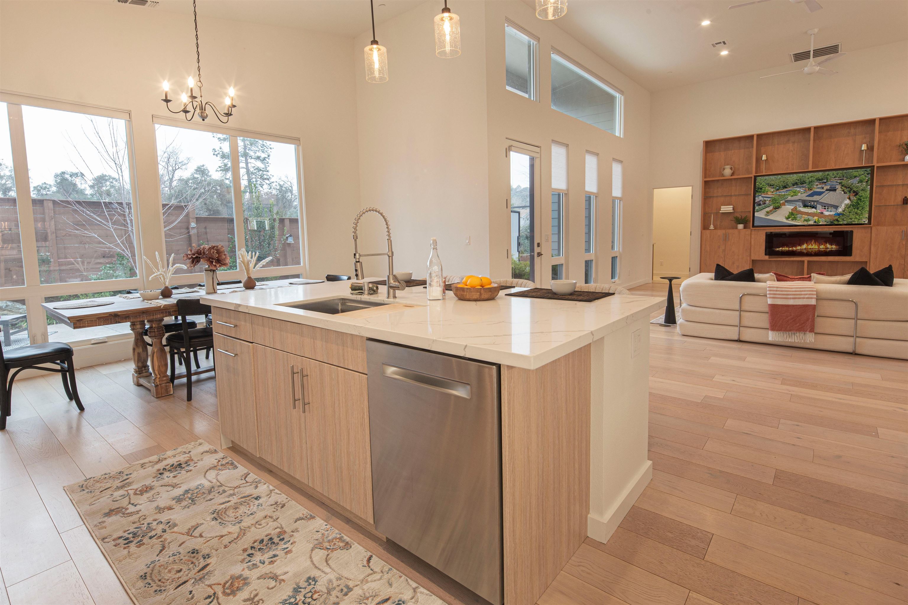 18870 Old Bridge Road Jamestown, CA 95327 - Photo 57 of 57 Kitchen with hanging light fixtures, stainless steel dishwasher, a fireplace, light stone counters, and open floor plan