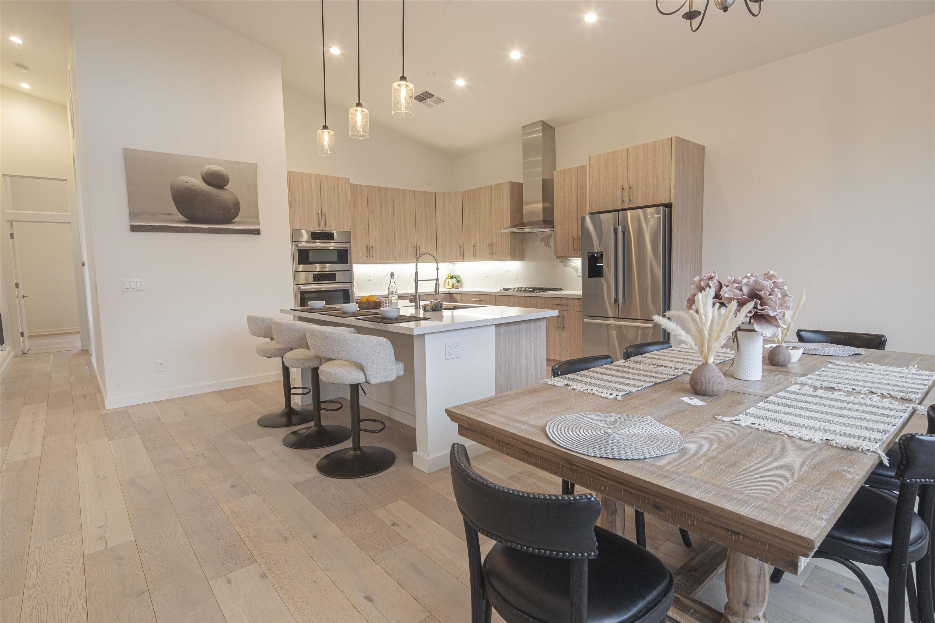 18870 Old Bridge Road Jamestown, CA 95327 - Photo 16 of 57 Kitchen with a breakfast bar, decorative light fixtures, a kitchen island with sink, appliances with stainless steel finishes, and high vaulted ceiling