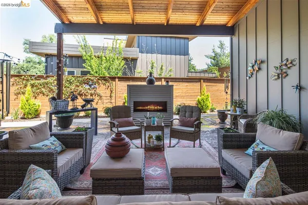 a outdoor living space with furniture and a fireplace