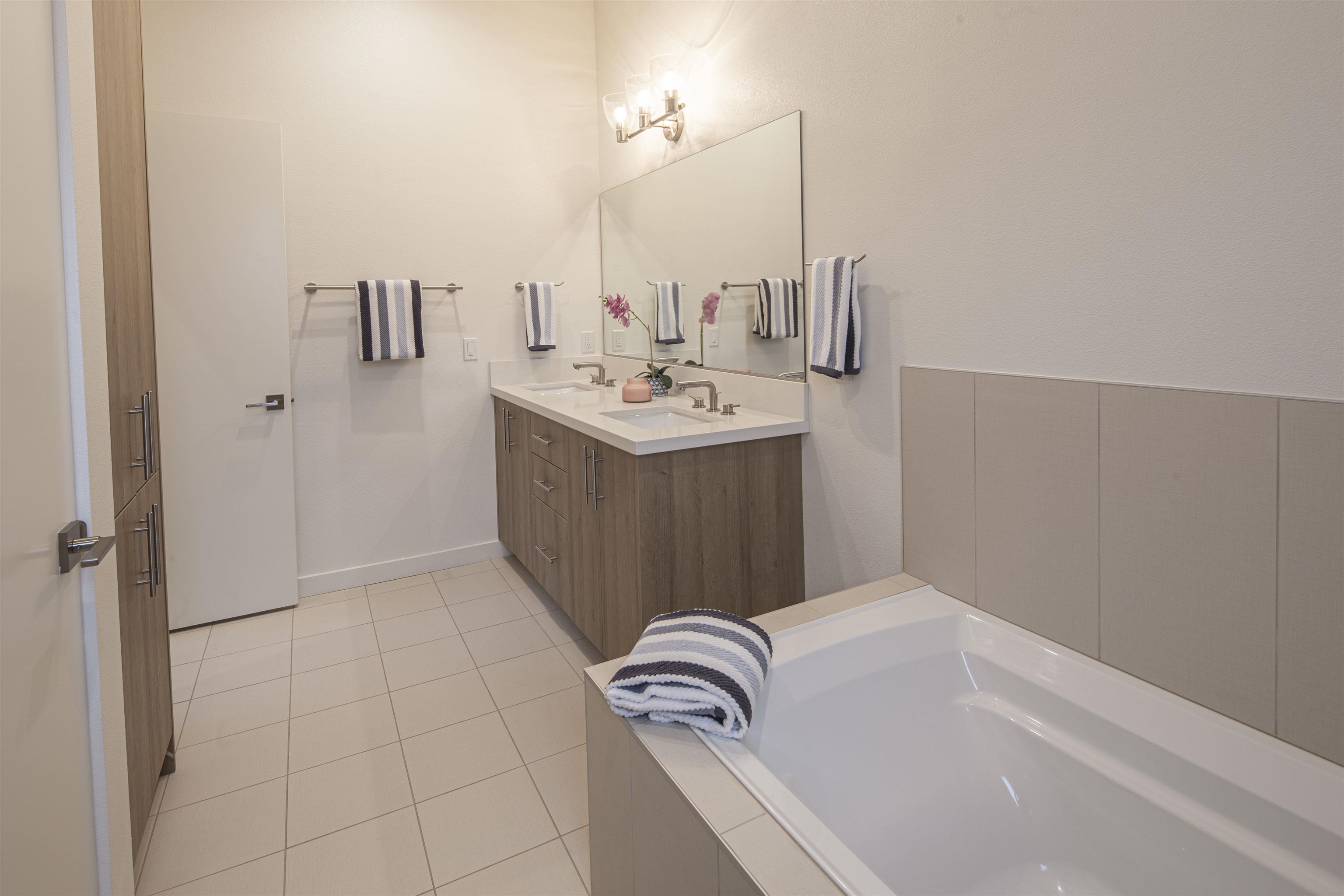 18870 Old Bridge Road Jamestown, CA 95327 - Photo 25 of 57 Full bath with double vanity, a bath, and light tile patterned floors
