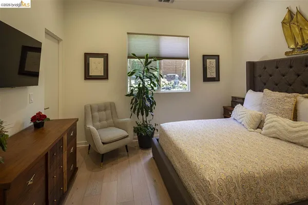 a bedroom with a bed and painting on the wall