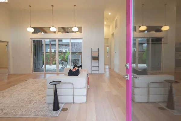 a living room with furniture large window and flat screen tv
