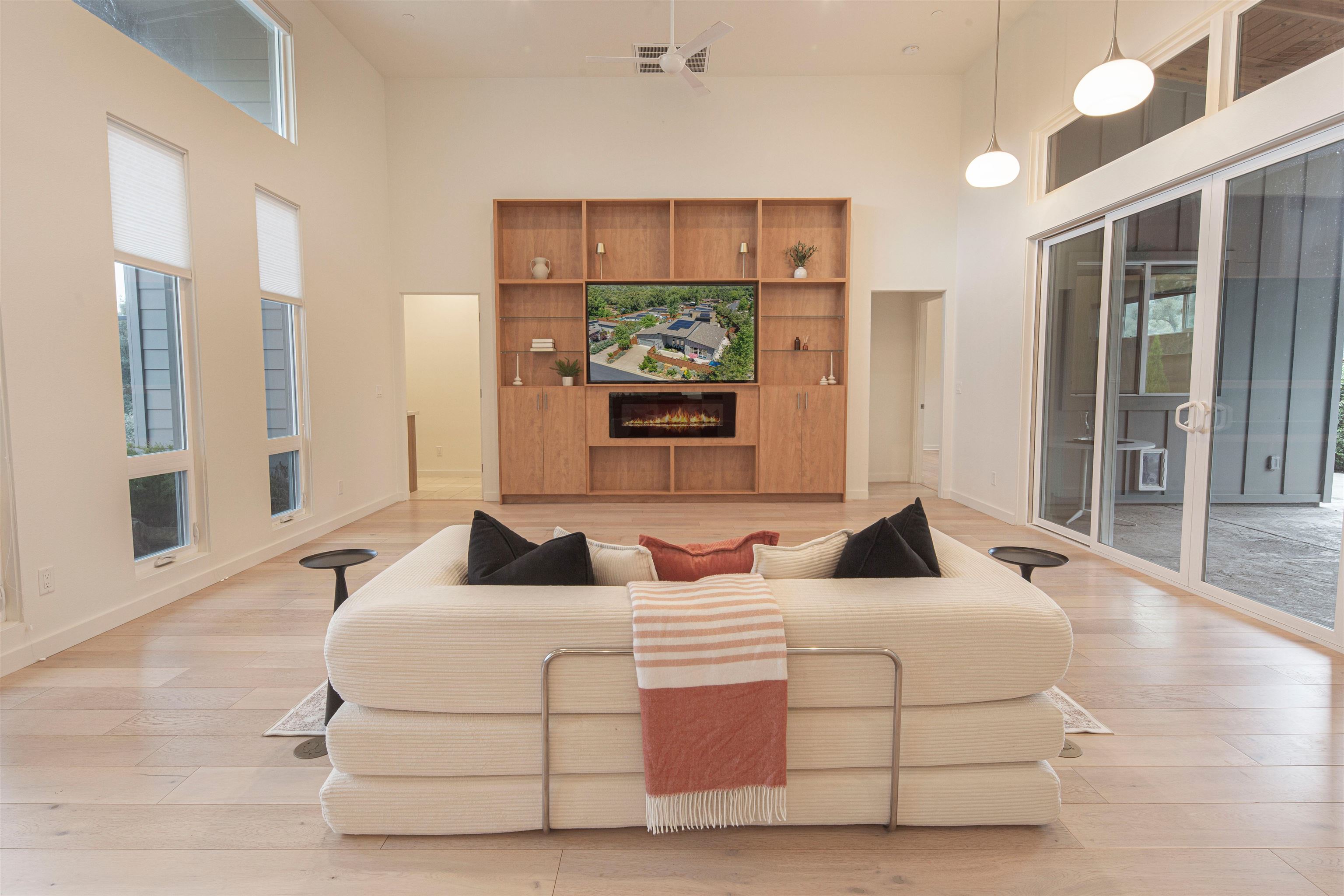 18870 Old Bridge Road Jamestown, CA 95327 - Photo 9 of 57 Living room with a towering ceiling, a tiled fireplace, and light wood finished floors