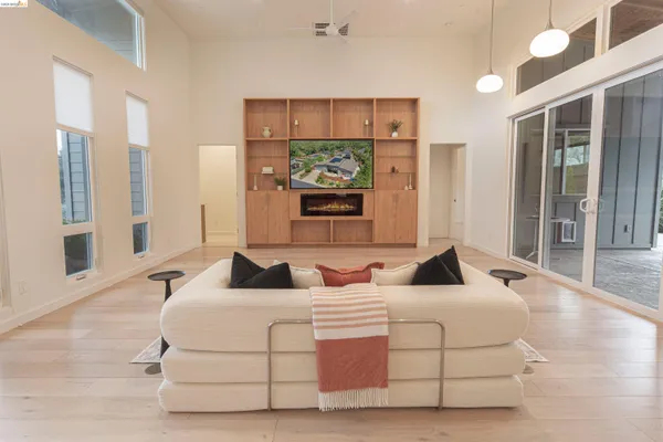 a large bedroom with a large bed and a view of kitchen