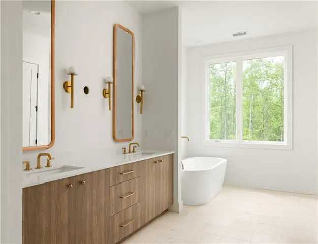 a bathroom with a double vanity sink a toilet and a window