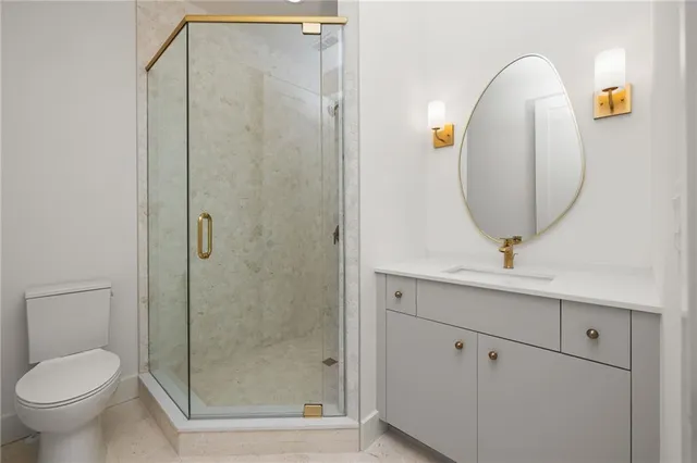 a bathroom with a toilet a sink and mirror
