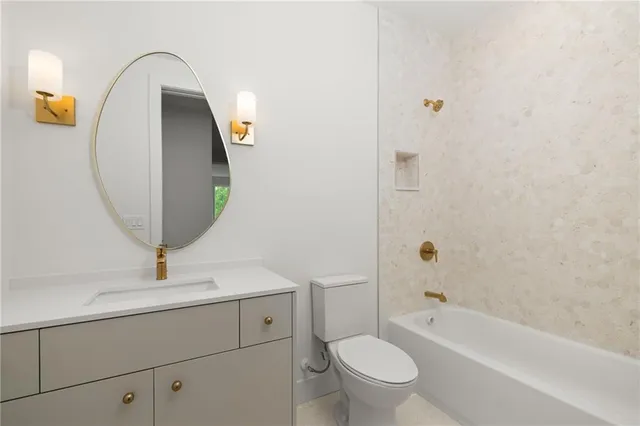 a bathroom with a sink a toilet and bathtub