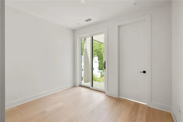 a view of an empty room with glass door