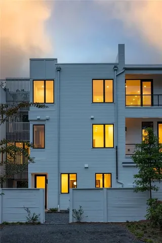 a view of brick house with a yard