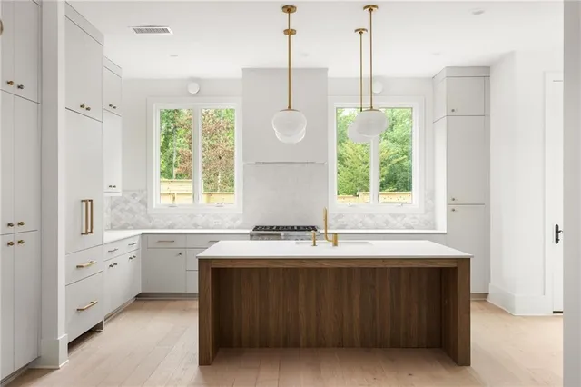 a bathroom with a double vanity sink window and a bathtub